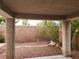 View of the backyard through a covered patio that opens up to gravel ground cover and a small tree at 5052 Whistling Acres Ave, Las Vegas, NV 89131