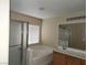 Full bath with shower, tub, vanity, and window at 5052 Whistling Acres Ave, Las Vegas, NV 89131