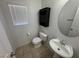 Bathroom featuring ceramic tile floor, toilet, cabinet and sink with mirror at 5052 Whistling Acres Ave, Las Vegas, NV 89131