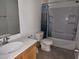 Bathroom features a shower-tub combo, toilet, sink and vanity with chrome fixtures at 5052 Whistling Acres Ave, Las Vegas, NV 89131