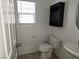 Half bath with white walls, decorative mirror, wall cabinet, and tiled flooring at 5052 Whistling Acres Ave, Las Vegas, NV 89131