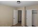 This bedroom has neutral walls, carpeted floors, a closet, and white doors at 5052 Whistling Acres Ave, Las Vegas, NV 89131