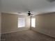 This bedroom has neutral walls, carpeted floors, ceiling fan, and white windows at 5052 Whistling Acres Ave, Las Vegas, NV 89131