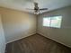 Carpeted bedroom with a ceiling fan and large window at 5052 Whistling Acres Ave, Las Vegas, NV 89131