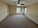 Large bedroom with an installed ceiling fan and natural light at 5052 Whistling Acres Ave, Las Vegas, NV 89131