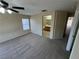 Spacious bedroom with a view of the bathroom and an installed ceiling fan at 5052 Whistling Acres Ave, Las Vegas, NV 89131