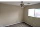 Cozy bedroom featuring neutral carpet, a ceiling fan, and a bright window at 5052 Whistling Acres Ave, Las Vegas, NV 89131