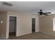 Bedroom with neutral walls, carpeted flooring, a ceiling fan, and closet space at 5052 Whistling Acres Ave, Las Vegas, NV 89131