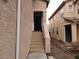 Exterior view of the home's entrance, showcasing the steps to the front door and the side yard at 5052 Whistling Acres Ave, Las Vegas, NV 89131
