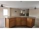 Spacious kitchen island featuring wood cabinets and a light countertop at 5052 Whistling Acres Ave, Las Vegas, NV 89131