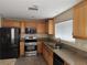 Kitchen featuring granite countertops, stainless steel appliances, and wood cabinetry at 5052 Whistling Acres Ave, Las Vegas, NV 89131