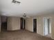 Neutral-toned living room with carpeted floors and ceiling fan, bathed in natural light at 5052 Whistling Acres Ave, Las Vegas, NV 89131
