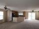 Open-concept living room with ceiling fans and a view of the kitchen at 5052 Whistling Acres Ave, Las Vegas, NV 89131
