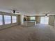 Open-concept living area with a view of the kitchen and access to the outdoors at 5052 Whistling Acres Ave, Las Vegas, NV 89131