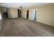 Large living area with carpet, neutral walls, and access to multiple rooms at 5052 Whistling Acres Ave, Las Vegas, NV 89131