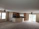 Open-concept living room with the kitchen in the background and ceiling fans at 5052 Whistling Acres Ave, Las Vegas, NV 89131