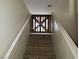 Hallway stairway with light beige paint and custom wooden gate at top of stairs at 5052 Whistling Acres Ave, Las Vegas, NV 89131
