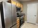Modern kitchen featuring stainless steel appliances, granite countertops, wood cabinets and tile flooring at 5055 W Hacienda Ave # 2102, Las Vegas, NV 89118