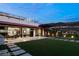 A luxurious backyard features a well manicured lawn, outdoor seating, and a covered patio at 515 Serenity Point Dr, Henderson, NV 89012