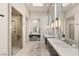 Modern bathroom with sleek fixtures, dual sinks, a glass-enclosed shower, and a dedicated vanity area at 515 Serenity Point Dr, Henderson, NV 89012