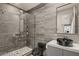 Modern bathroom with sleek gray tile, a glass-enclosed shower, and a stylish vessel sink at 515 Serenity Point Dr, Henderson, NV 89012