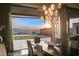 An elegant dining room with a decorative chandelier and sliding glass doors leading to a patio with scenic views at 515 Serenity Point Dr, Henderson, NV 89012