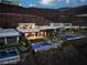 Modern home with multiple pools, sleek design, and luxurious outdoor space against a mountain backdrop at 515 Serenity Point Dr, Henderson, NV 89012