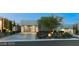 Modern home showcasing a glass garage door, desert landscaping, and paved driveway at 515 Serenity Point Dr, Henderson, NV 89012