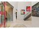 Grand foyer featuring a glass sliding door, a floating staircase, and contemporary artwork at 515 Serenity Point Dr, Henderson, NV 89012