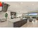 Open kitchen and living area featuring a large kitchen island, built-in bar, and floor-to-ceiling windows at 515 Serenity Point Dr, Henderson, NV 89012