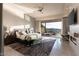 Spacious main bedroom with sliding glass doors to a private patio offering mountain views and modern furnishings at 515 Serenity Point Dr, Henderson, NV 89012