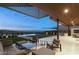Elegant outdoor lounge area with comfortable seating, a grill, and city views at 515 Serenity Point Dr, Henderson, NV 89012