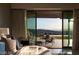 Breathtaking mountain and city views from the main bedroom's private patio with comfortable seating at 515 Serenity Point Dr, Henderson, NV 89012