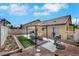 Inviting backyard patio area features a pergola, grill, and artificial turf at 520 Blackbird Knoll Ct, North Las Vegas, NV 89084