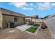 Relaxing backyard patio with pergola, artificial turf, and gravel landscaping at 520 Blackbird Knoll Ct, North Las Vegas, NV 89084