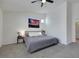 Bright bedroom with a ceiling fan, neutral decor, and a large picture on the wall at 520 Blackbird Knoll Ct, North Las Vegas, NV 89084