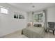 Bright bedroom with grey decor, light wood floors and natural light from the window at 520 Blackbird Knoll Ct, North Las Vegas, NV 89084