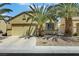Charming single-story home with a two-car garage, featuring palm trees and low-maintenance desert landscaping at 520 Blackbird Knoll Ct, North Las Vegas, NV 89084