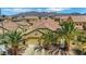 Front view of a home featuring a driveway and desert landscaping at 520 Blackbird Knoll Ct, North Las Vegas, NV 89084