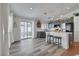 Modern kitchen with gray cabinets, quartz countertops, stainless steel appliances, and wood-look flooring at 520 Blackbird Knoll Ct, North Las Vegas, NV 89084