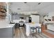 Modern kitchen features gray cabinets, white countertops, stainless steel appliances, and an island with seating at 520 Blackbird Knoll Ct, North Las Vegas, NV 89084