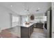 Open kitchen floor plan with an island, gray cabinets, stainless steel appliances, and wood-look floors throughout at 520 Blackbird Knoll Ct, North Las Vegas, NV 89084