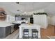 A kitchen featuring an island with seating, gray cabinets, stainless steel appliances, and stylish pendant lighting at 520 Blackbird Knoll Ct, North Las Vegas, NV 89084