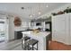 Modern kitchen features an island, gray cabinets, quartz countertops, stainless steel appliances, and wood-look floors at 520 Blackbird Knoll Ct, North Las Vegas, NV 89084