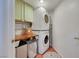 Functional laundry room with washer, dryer, and ample storage space at 520 Blackbird Knoll Ct, North Las Vegas, NV 89084