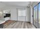 Bright living room with high ceilings, wood-look floors, a large window, and sliding glass doors at 520 Blackbird Knoll Ct, North Las Vegas, NV 89084