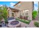 Charming backyard features a stone patio, outdoor seating, a fire pit, and lush landscaping at 5503 Jinan St, Las Vegas, NV 89148