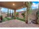 An inviting backyard with a covered patio, stone pavers, and manicured landscaping at 5503 Jinan St, Las Vegas, NV 89148