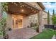 Backyard featuring a covered patio, stone pavers, artificial turf, and mature landscaping at 5503 Jinan St, Las Vegas, NV 89148