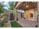 An outdoor patio featuring stone pavers, a rock waterfall, and manicured landscaping at 5503 Jinan St, Las Vegas, NV 89148